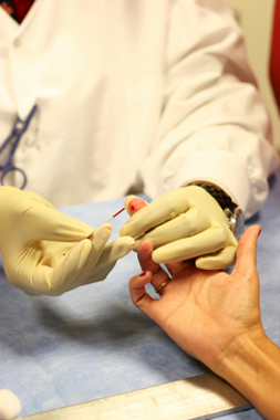 person receiving finger-prick blood test